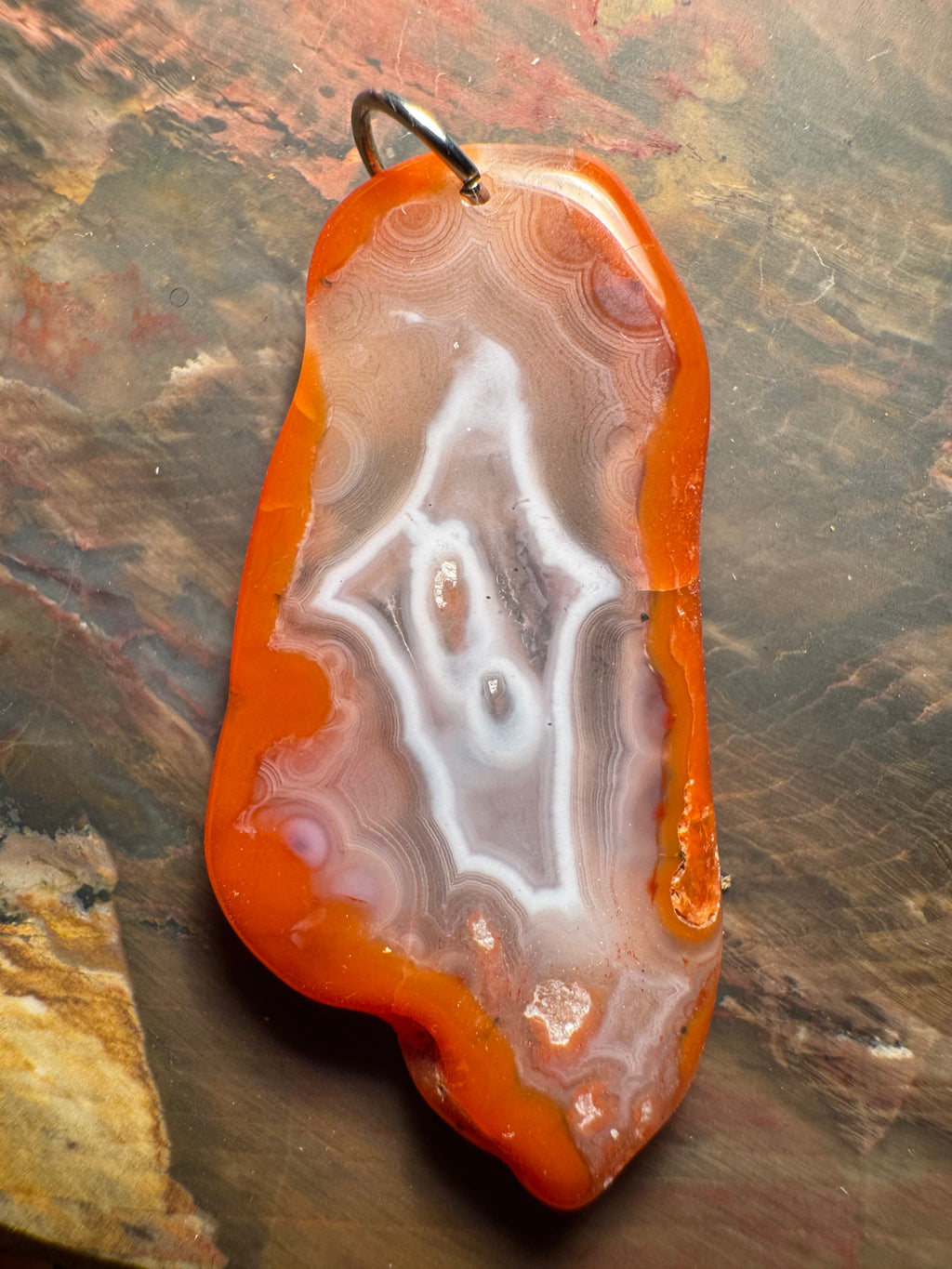 Agate pendant with eyes and fine bands, Morocco